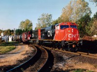 Very few locomotives I like less than the SD70s on CN. The only exceptions are CN SD75s and those dirty GEs on CP. But, those SDs with the runny watercolour paint and tattered appearance actually were rather attractive when new. Here is an example; CN 5617, only 4 days old, followed by 5614, in its' 22nd day, about to enter the Grimsby Sub., westbound. The track running left in the photo is part of the wye as seen from Stanley Av. These locomotives have been around 20 years already.