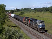 CN 376 rolls through Newtonville with 8103, an ex-EMD demonstrator unit, leading the way. The 8103 would encounter issues east of here and was cut off in Belleville.