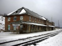 Further to Mr. Mooney's August 9, 1985 photo from the backside of CN's Hornepayne station, here is what it looked liked from the front side 16 years later in December 2001.  The absence of tenants, heat and caretakers has certainly taken its toll on the once busy structure. I am sure that in 2015, 14 years after this shot, the station and attached buildings must be a total disaster. The shop building (behind me) was still active in 2001 when I was there commissioning a new snow fighting machine. It stored CN vehicles, some work equipment machines, and a few pieces of rolling stock required for emergency purposes, and, the under roof turntable was still functioning. The town, the station, the shops and yard are but a shadow of themselves from when I lived and worked there in the 60's, 70's and 80's. Hornepayne has become but another casualty of the bigger, better, stronger, faster, more reliable trains, track, and service personnel across the system. Although that is a sad commentary, it is a good thing for railroading.