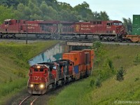 The classic over/under at Beare. It's pretty easy to do. First, open two shots in photoshop, one CP and one CN... heh. Ok, it's legit. CN 2100, 2544, and 5705 lead 149's train up the grade while CP 142's crew will be notching up 8712 and 8522 as their tail is now clear Staines. Back in the day, they'd already be rolling pretty good through here, but with 10,000' or greater trains on the Belleville Sub now, they're still watching the counter as they approach the crossing with CN. And CN? 10,000' is so 2001. 1439hrs.