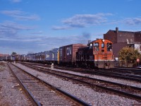 CN 7395 leads a transfer through St. Henri with a mixture of VIA equipment and two CN box cars.  The VIA equipment includes RDCs, Steam Generators and baggage cars, sporting CN, CP and VIA schemes.  