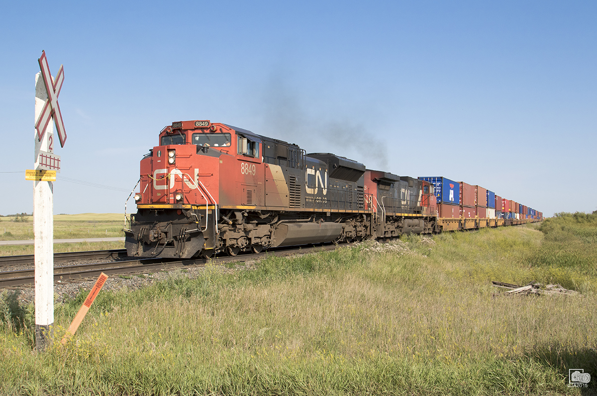 3 miles west of Melville, SK CN 8849 takes charge on this westbound Q series train.