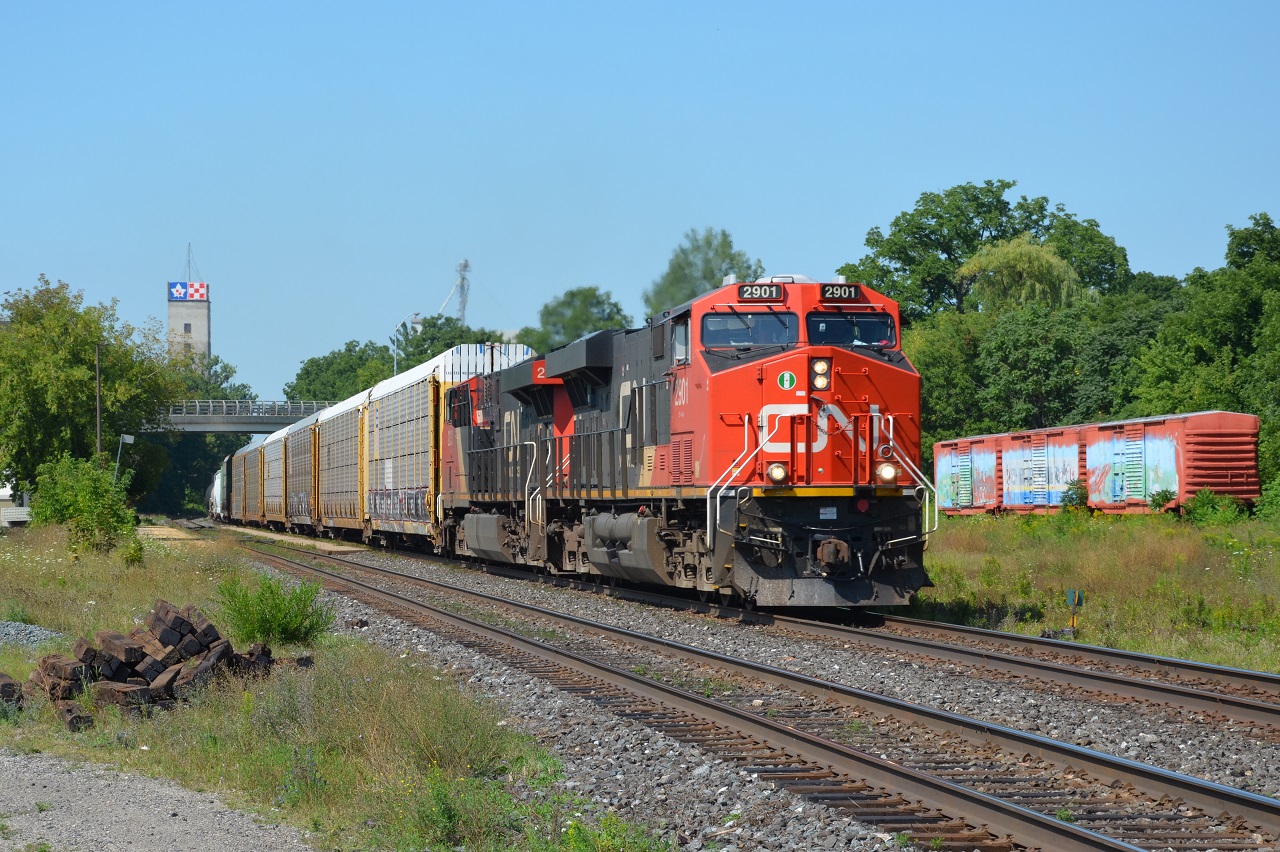 M382 passes the box car murals out front of the Woodstock VIA station on the North track.