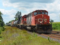 An old EMD leader takes charge of CN M330 leading a standard cab through mile 7.3 of the Strathroy Sub near Frank Lane. Wonder if the crew chose the SD40-2W to lead?