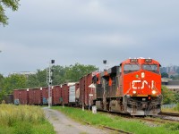 <b>New signals in St-Henri.</b> CN X324 with two ES44AC units (CN 2872 & CN 2889) rounds a curve in the St-Henri neighbourhood of Montreal, passing a new set of signals (not yet operational) in the process.