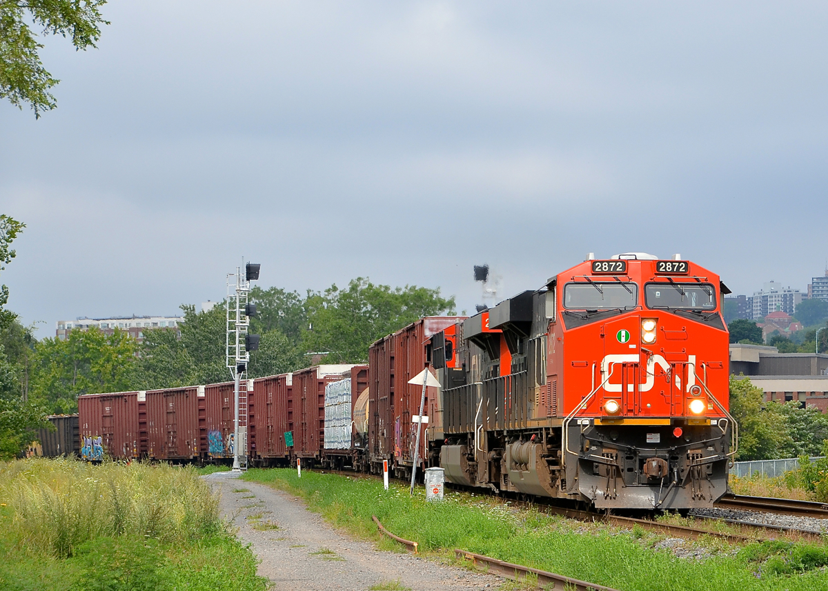 New signals in St-Henri. CN X324 with two ES44AC units (CN 2872 & CN 2889) rounds a curve in the St-Henri neighbourhood of Montreal, passing a new set of signals (not yet operational) in the process.