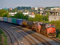 Back when CN was running CN 710, the foreign power from that train would often head back west on CN 309. Here faded warbonnet BNSF 699 is trailing CN 2241 in Montreal West on CN 309.