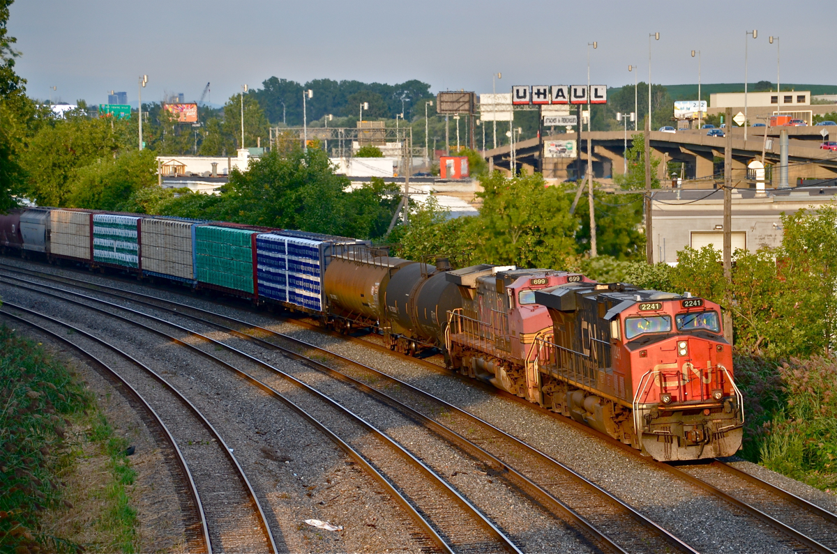 Back when CN was running CN 710, the foreign power from that train would often head back west on CN 309. Here faded warbonnet BNSF 699 is trailing CN 2241 in Montreal West on CN 309.