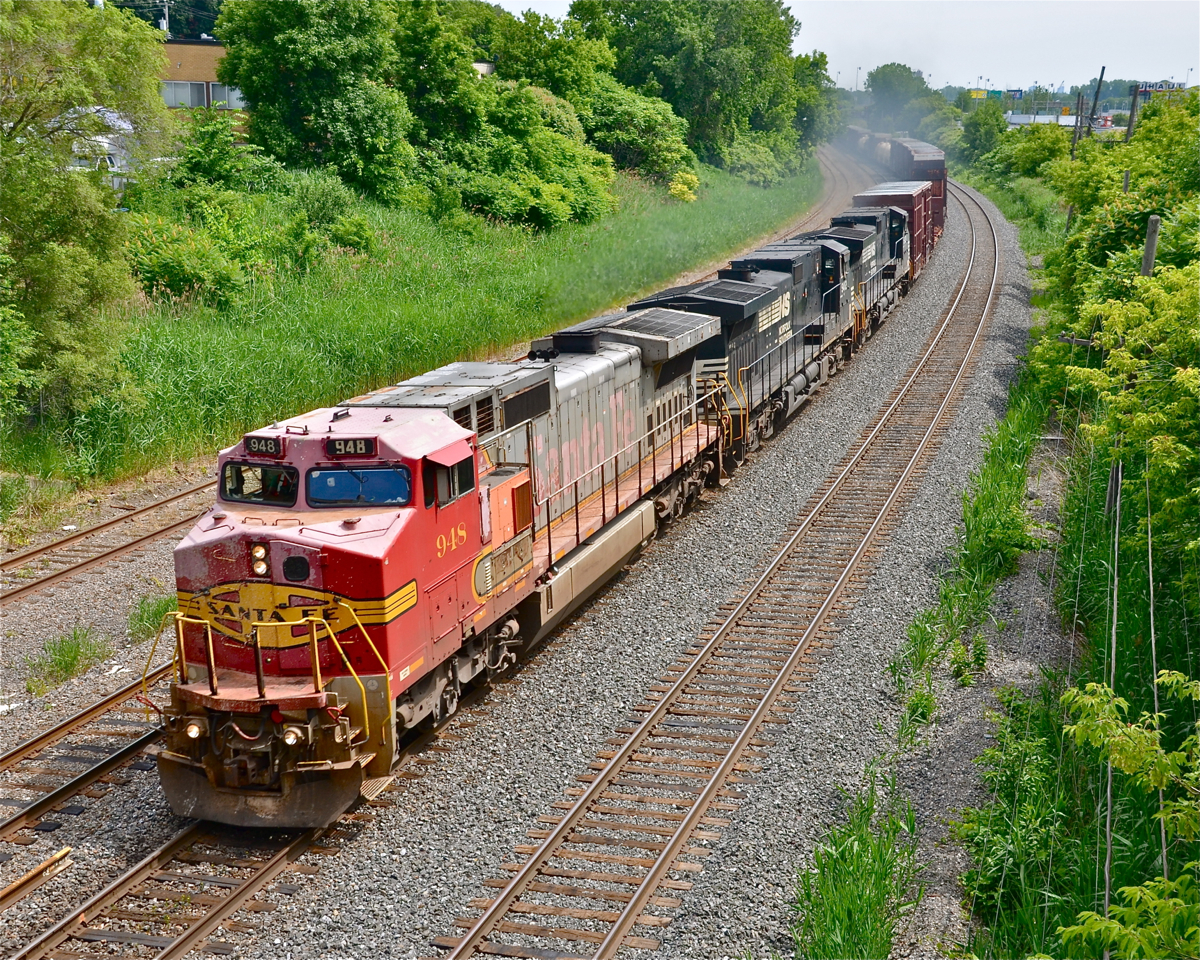 A late CN 529 has BNSF 948 in faded warbonnet paint leading. Trailing is NS 9412 & NS 9713.