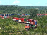 ES44DC 2327 shoves Vancouver bound train 101 up the hill through Coniston. Over 13500 feet of traffic lead by CN 8019, middle DP CN 2682 and tail end remote CN 2327. 