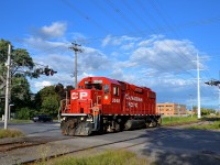 <b>Crossing Lafleur Avenue.</b> CP 3048 is crossing Lafleur Avenue on CP's Lasalle Loop. It is returning to its train after switching out Total Canada (one of two clients still served by CP on this once busy line).