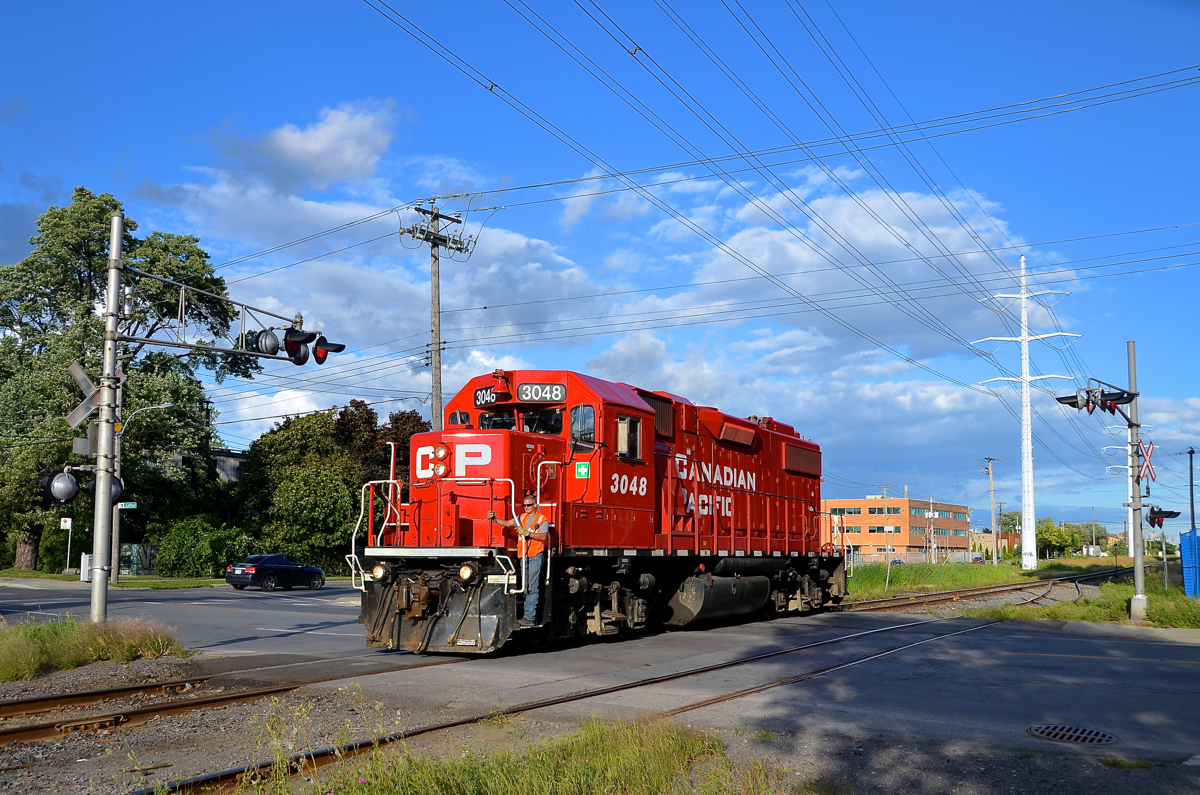 Crossing Lafleur Avenue. CP 3048 is crossing Lafleur Avenue on CP's Lasalle Loop. It is returning to its train after switching out Total Canada (one of two clients still served by CP on this once busy line).