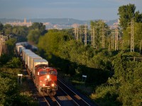 <b>That sweet evening light.</b> CP 133 (the westbound Expressway) has CP 8946 and CP 9633 for power as it passes through Pointe-Claire during some nice evening light.