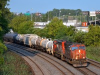 <b>An SD75I and SD40-2W on CN 323.</b> CN 323 is returning from Vermont with SD75I CN 5743 and SD40-2W CN 5281 as it rounds a curve in Montreal West.