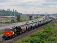 <b>Fresh power leading CN 305.</b> Delivered to CN only about a week ago, CN 3009 is in charge of CN 305 as it approaches a crew change at Turcot West. Older GEVO CN 2934 is mid-train. The skyline of downtown Montreal is visible at left.
