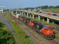 <b>I'm going to miss this spot.</b> The Angrignon overpass over CN's busy Montreal sub makes a nice location for eastbound's in the morning and westbound's in the afternoon, but this area will be changing drastically in the future with CN's tracks moving further north and much of the highway and overpass infrastructure changing. This morning I shot CN 120 approaching the overpass during some nice light (it would cloud over not too long after). The lashup had 4 unit types (ES44DC CN 2311, SD70M-2 CN 8917, Dash8-40CW CN 2141 & GP40-2L(W) CN 9673).