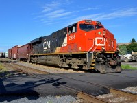 <b>A brand new crossing.</b> Infrastructure work in the Turcot area of Montreal will require CN's main line in the area (the Montreal sub) to shift a bit further north than where it is now. As part of this work, the de Courcelle crossing has been closed (removed really) and a new pedestrian-only crossing has been installed recently a couple of hundred metres east of the old street crossing. Here CN 324 with CN 2858 solo passes the crossing on its way to St. Albans, Vermont.