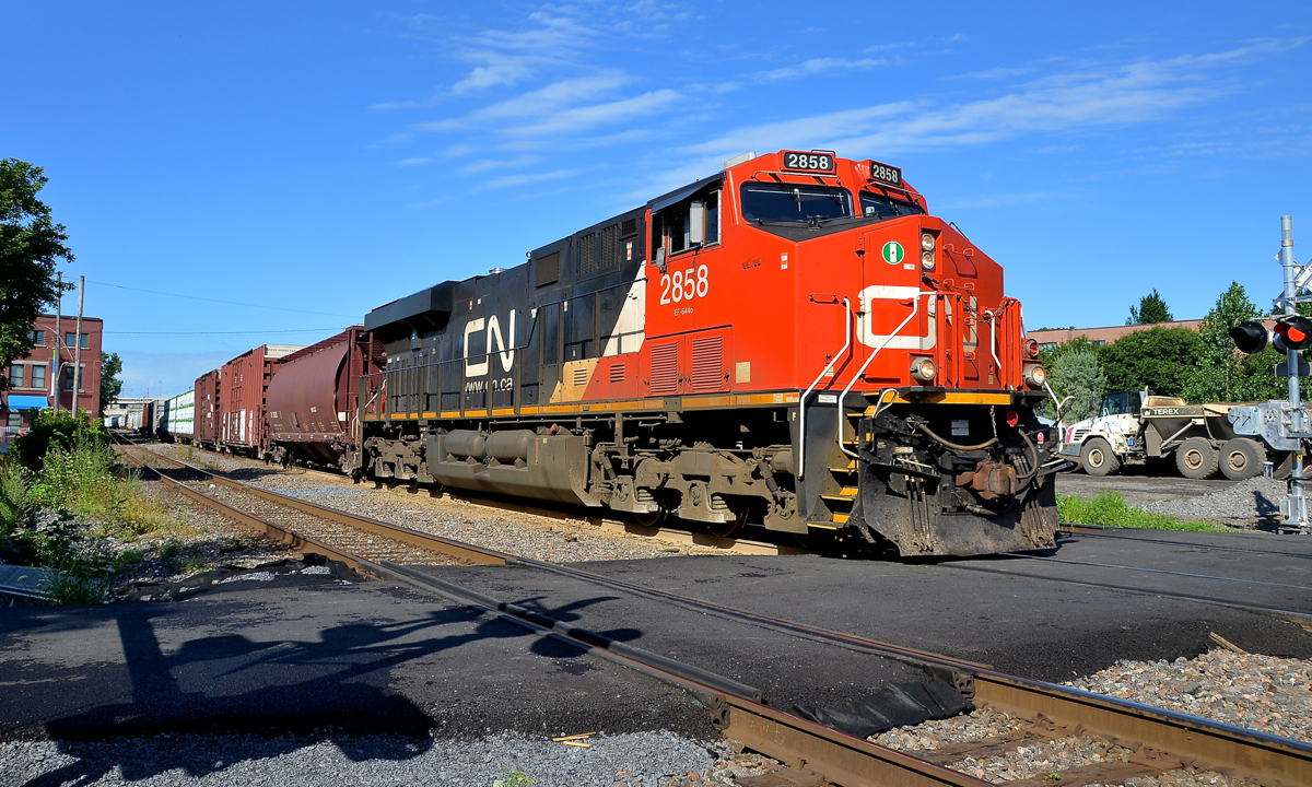 A brand new crossing. Infrastructure work in the Turcot area of Montreal will require CN's main line in the area (the Montreal sub) to shit a bit further north than where it is now. As part of this work, the de Courcelle crossing has been closed (removed really) and a new pedestrian-only crossing has been installed recently a couple of hundred metres east of the old street crossing. Here CN 324 with CN 2858 solo passes the crossing on its way to St. Albans, Vermont.