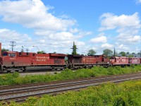 [Editors note: The GP9's make the shot, despite the high-ish weeds] CP 119 has two horribly faded GP9's in tow as it leaves Dorval after finishing putting its train together in Lachine. Lashup is CP 8841, CP 9590, CP 1604 & CP 1547.