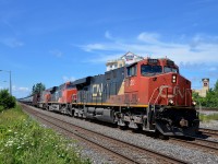 CN 720 has an all-DC, elephant style lashup led by CN's first GEVO (CN 2220, CN 2265 & CN 5721) as it heads through the curve just past the VIA Rail Dorval Station.