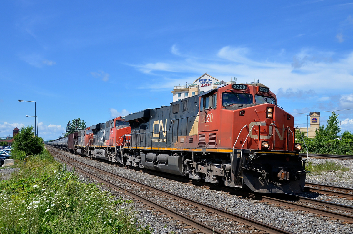 CN 720 has an all-DC, elephant style lashup led by CN's first GEVO (CN 2220, CN 2265 & CN 5721) as it heads through the curve just past the VIA Rail Dorval Station.