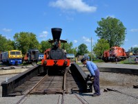 <b>Steam engine now turned</b> The 'John Molson' has just been spun on the ex-CP turntable at Exporail and will soon back out. At right some people enjoy the turntable demonstration. Even more people are out of sight at right, enjoying the shade provided by Hays Station on this stifling afternoon. At left is LRC-3 VIA 6921 and 70 tonner CN 30 and GP9 CP 1608 are at right.