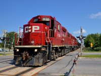 <b>Rail train.</b> A pair of GP38-2's (CP 3130 & CP 3047) lead a rail train north on CP's Adirondack sub. After having dropped rail in St-Constant and Delson they are heading to South Junction to drop rail in Montreal West.