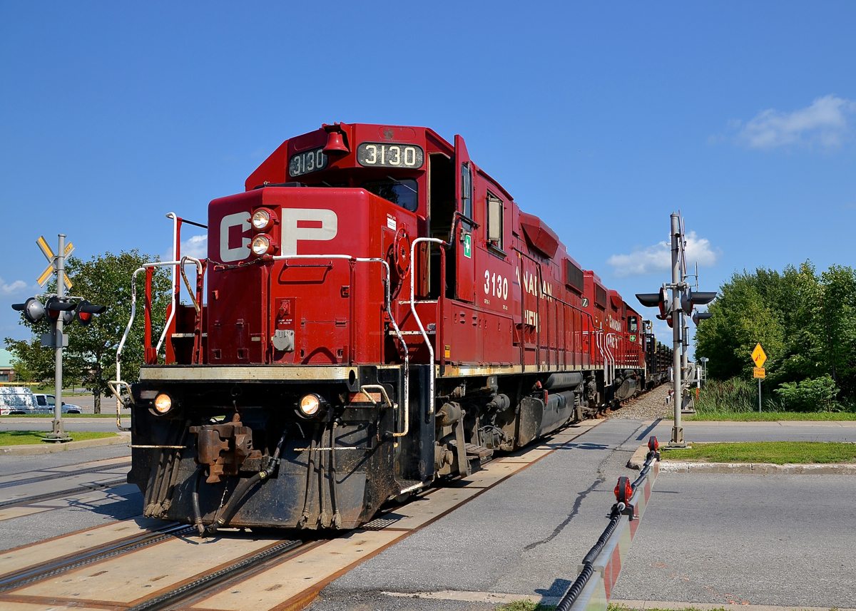 Rail train. A pair of GP38-2's (CP 3130 & CP 3047) lead a rail train north on CP's Adirondack sub. After having dropped rail in St-Constant and Delson they are heading to South Junction to drop rail in Montreal West.
