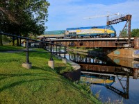 <b>VIA 909 reflected in the canal.</b> VIA 909 leads a slightly late VIA 33 from Quebec City over the Lachine Canal. After loading passengers at Montreal's Central Station, the train will back up and head to Ottawa.