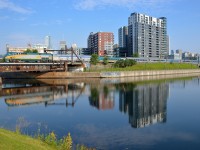 <b>Not quite a solid stainless steel consist.</b> An LRC first class car mars what otherwise would have been a solid stainless steel consist as VIA 63 backs up to Montreal's Central Station with VIA 902 pushing.