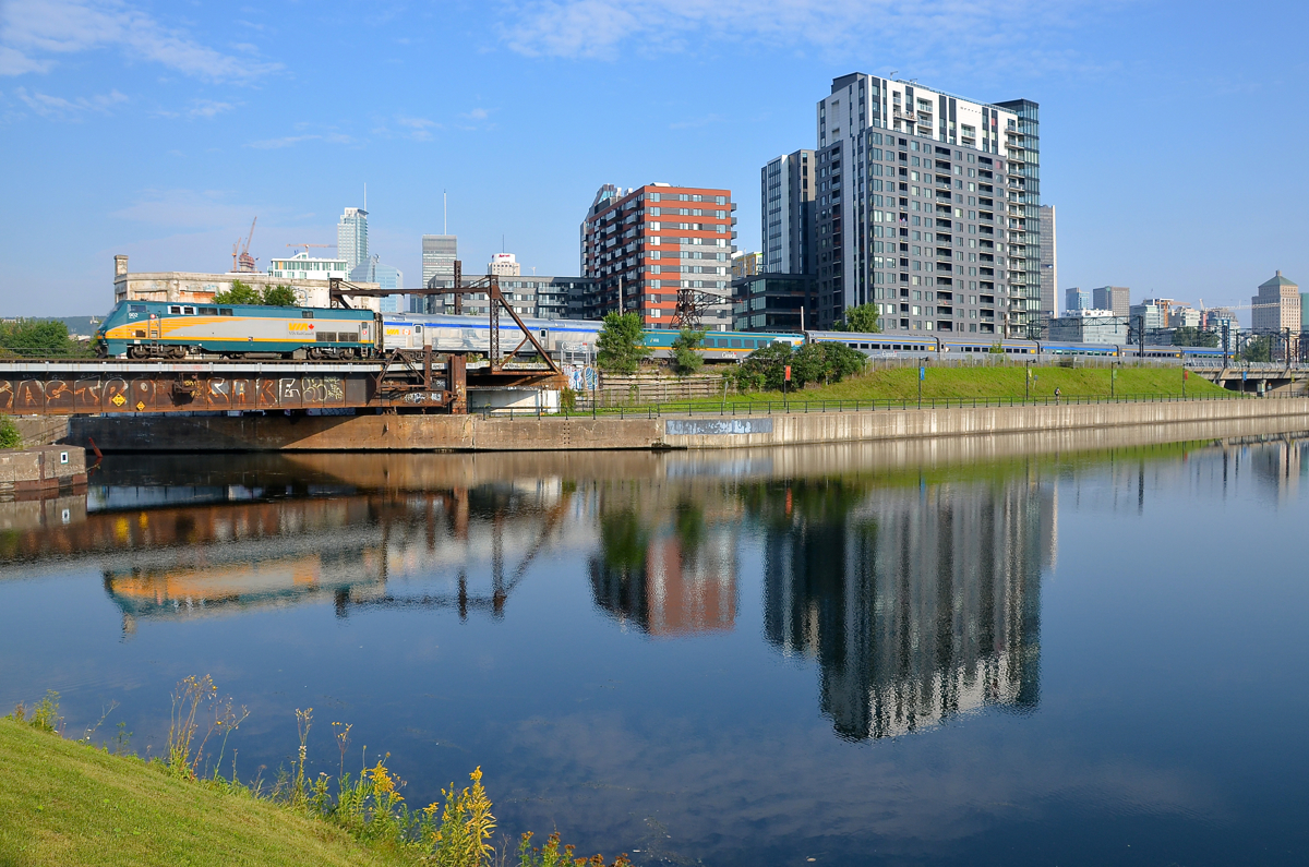 Not quite a solid stainless steel consist. An LRC first class car mars what otherwise would have been a solid stainless steel consist as VIA 63 backs up to Montreal's Central Station with VIA 902 pushing.