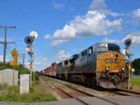 A CSXT ES40DC and SD50-2 (5312 & 8593) lead a later than usual CN 327 through Beaconsfield. They are about to cross over Woodland Avenue.