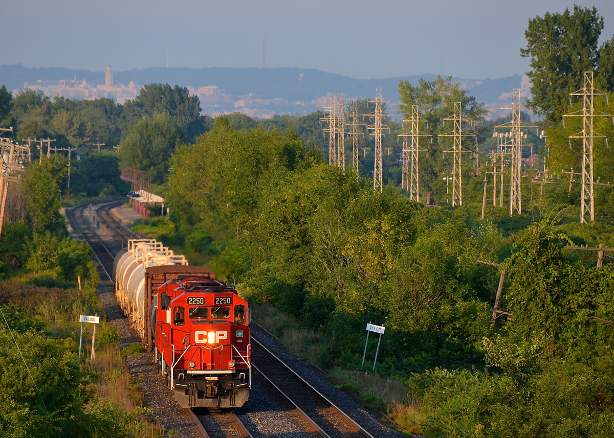 The Dorion Turn through Pointe-Claire. CP 2250 & CP 2256 lead the Dorion Turn westbound through Pointe-Claire. Behind it is Pointe-Claire Station and way in the distance is Mount-Royal