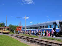 There's a decent sized lineup to get on the Sunday-only excursion train at Exporail, which consists of CP 1608 and ex-CP AMT 827 on this sunny afternoon. At left the streetcar is about to leave Barringston station.