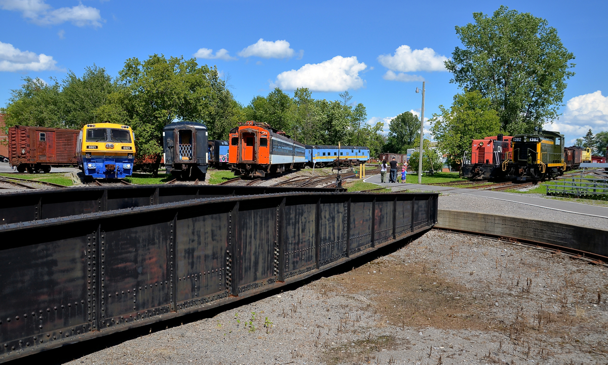 Around the turntable. A wide array of equipment is around Exporail's ex-CP turntable, including LRC -3 VIA 6921, two CN passenger cars, 70 tonner CN 30 and SW1200RSm CN 1382.