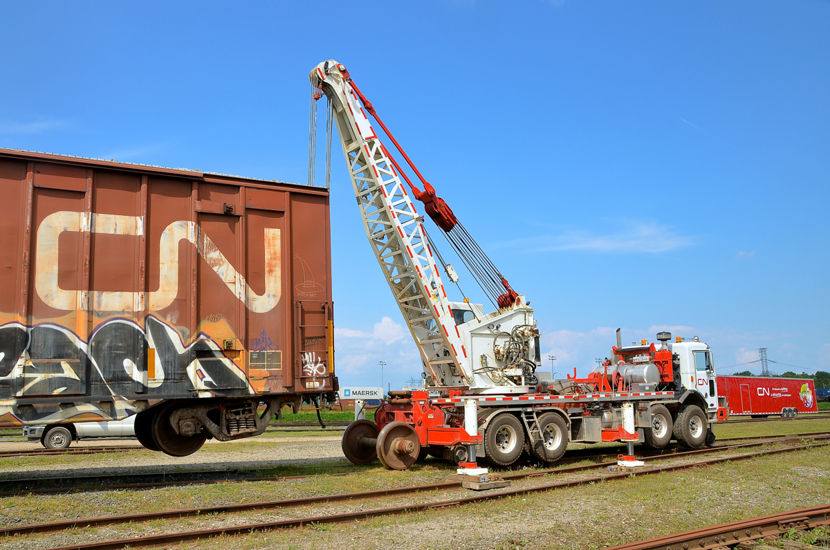 Up in the air. As part of the events for CN family day at Joffre yard, a CN crew demonstrates how to change out an axle on a boxcar.