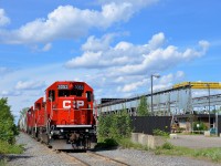 A CP switcher with three GP38-2's (CP 3053, CP 3204 & CP 3032) is stopped on the Seaway Spur, its crew just having taxied away, presumably they ran out of hours. At right is a junkyard in this very industrial section of the south shore, which has a number of customers served by CP.