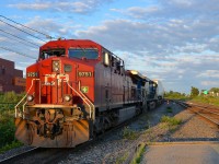 CP 133 heads west with CP 9751 (its plow still painted from its use in the movie <i>Unstoppable</i>) and CEFX 1041 through Lachine a bit before sunset.