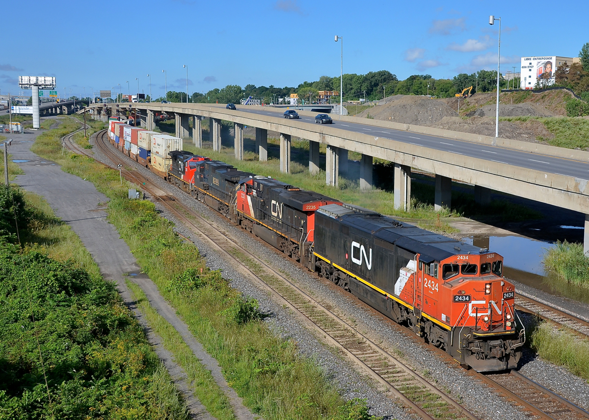 GE variety and a repainted cowl leader. CN 120 has a varied GE lashup, including Dash8-40CM CN 2434 leading, which was repainted in 2008. Trailing is ES44DC CN 2235, Dash9-44CW BCOL 4648 and ex-ATSF Dash8-40CW CN 2193. The train is passing through Turcot West in Montreal, ducking underneath the eastbound lanes of highway 20.
