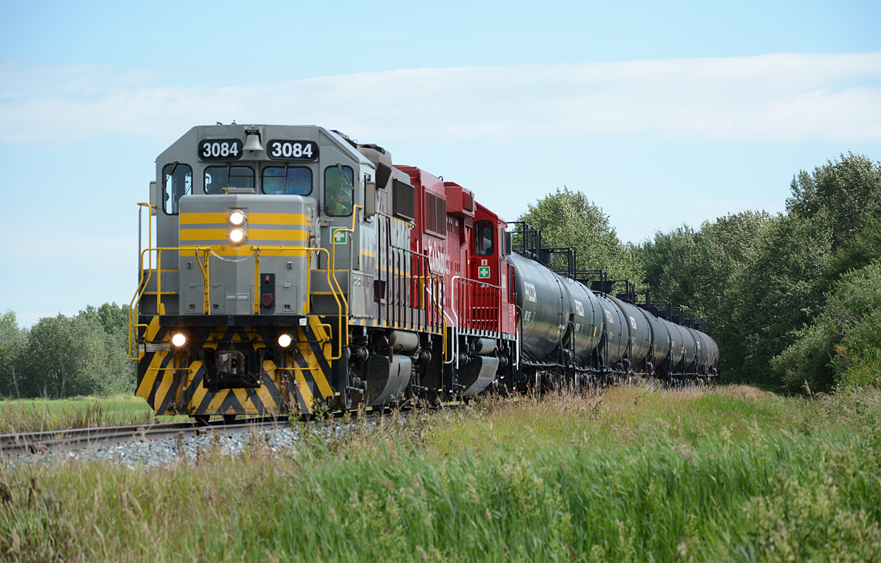 CP 3084 (GP38-2) and CP 2323 (GP20C-ECO) lead an outbound train of 10 empty tank cars (marked Liquified Petroleum Gas) on the Hoadley Sub. The only customer on this subdivision is the Rimbey Gas Plant.