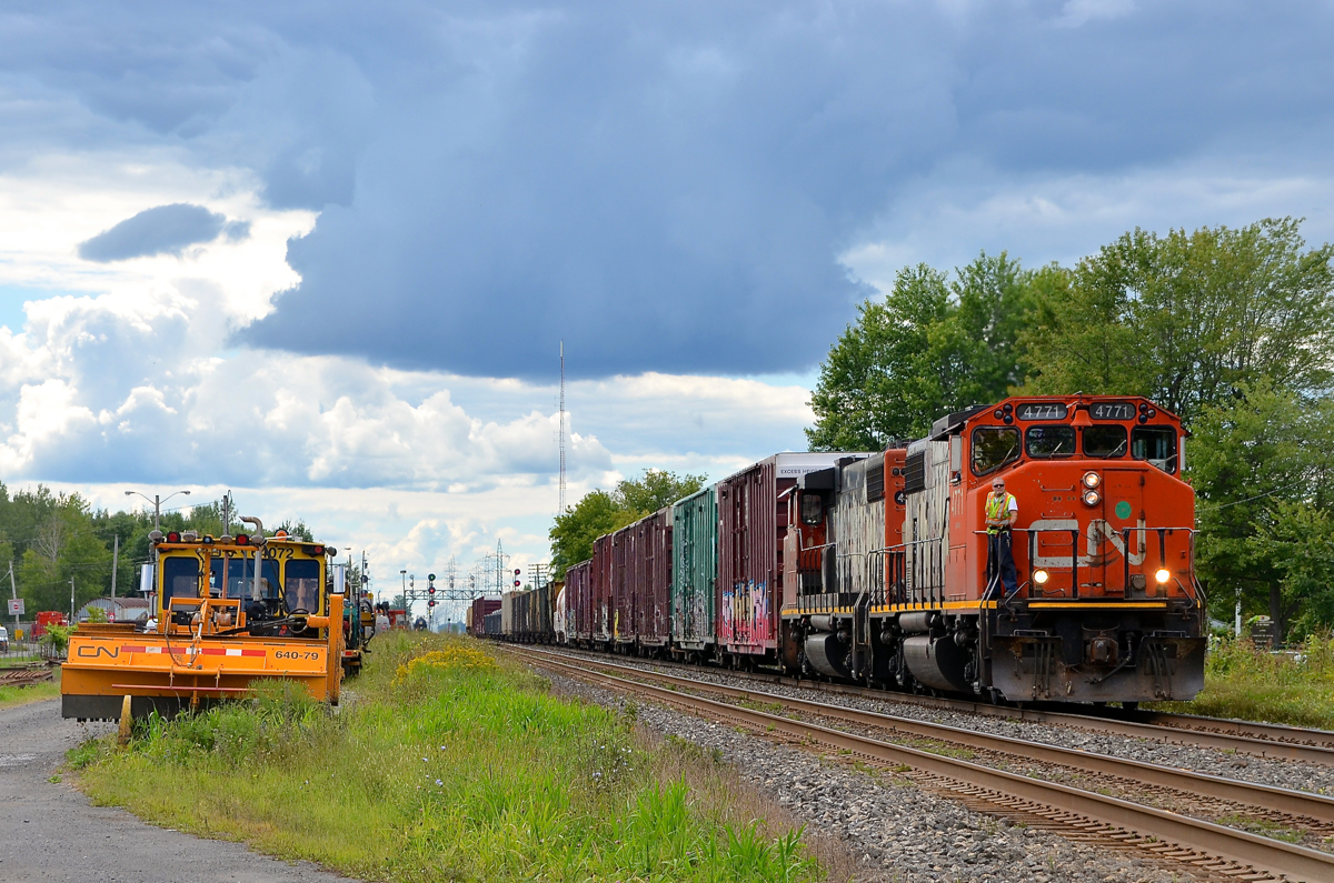 Waiting for their signal. CN 589 has just come off the mostly passenger-only VIA Rail Alexandria sub and is waiting for its signal on CN's Kingston sub in Coteau. It has to wait for CN 377 to come on the south track before it can cross over and back into the yard on the south track. CN 589 has a pair of worn GP38-2W's for power (CN 4771 & CN 4802).
