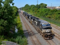 <b>Double your CN 528.</b> CN 528 has two day's worth of CN 528/529 power (CP 930/931 while on CP tracks) and a longer train than usual as it exits Taschereau Yard with NS 9820, NS 9970, NS 8460 & NS 8359 for power.