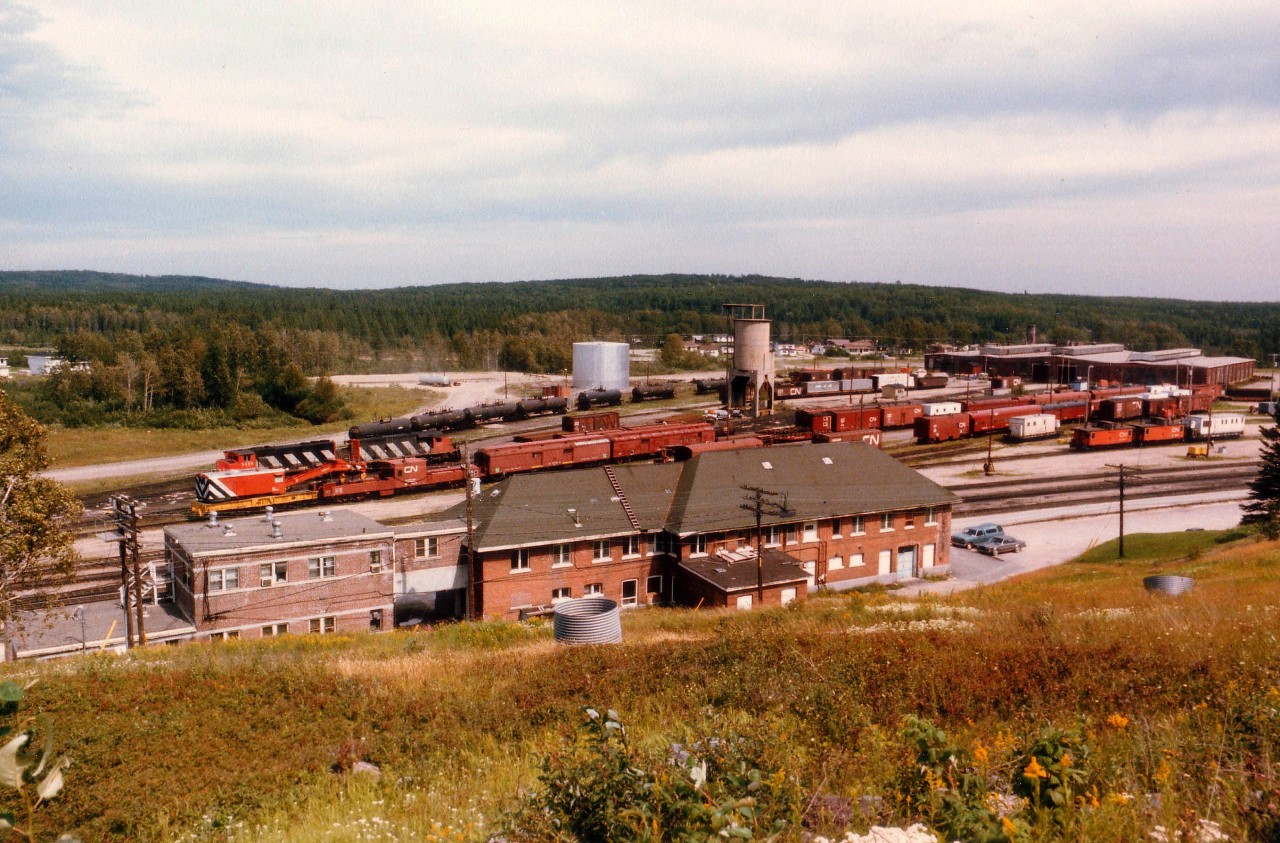 Remote and Dreary is what I think of Hornepayne, although I know some on this list might differ. First time I went up here in the '70s even the highway was but a shadow of what a highway should be. But for the train buff the place has its highlights. Note the huge station in the foreground, and administrative offices to the left. Note the huge train sheds, indoor shop and the world's last indoor roundhouse. Why? Because it is so bloody cold up there, thats why. Unfortunately the station has been closed, it is, at last visit, a forelorn and empty structure falling to the vandals. Neither the RR nor the town seems to want it. I understand that due to the elements (as in 'winter') a central all-purpose building that houses everything vital to operation of the community was constructed downtown. I had heard, however, that it was facing forclosure due to lack of tenants and local business. Now that I think of it, this place deserves another visit. :o)