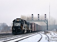 <b><I>The Staple of the Day.</I></b> Still fresh into photography, I met up with then railfan David Graham in Guelph and we headed down to catch some action on CN's busy Dundas Subdivision. The goal to capture the endangered Norfolk Southern trains 327/328. We met up with one of David's good friends, Steve Host. Upon arrival at Paris, the group of us didn't have to wait long before NS 327 came blaring around the corner with NS GP59 4640 leading FURX SD40-2 1146, crossing over to the south main. Diesel smoke spewing out of the engines as the engineer controls his impressive string of auto boxes in tow. Fifteen minutes later NS 328 blew by with an even more impressive lash-up. I was hooked!