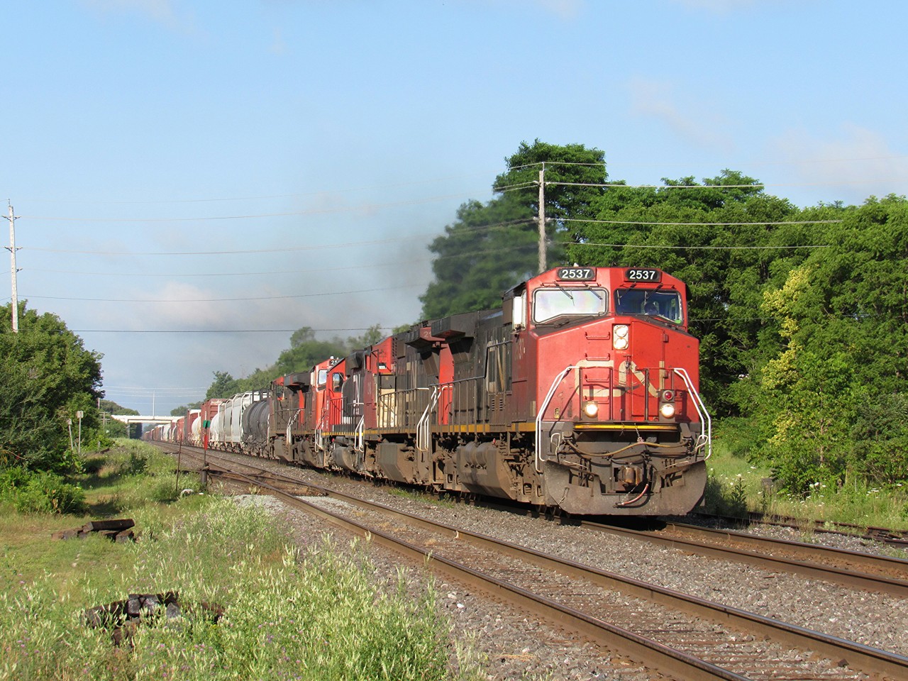 I was on my way to London, Ontario for a day of railfanning, when I heard about CN M384 heading east, with a nice lash up. So I decided to get off the 401, and catch 384 in one of my favourite spots. That spot is Ingersoll, Ontario. I arrived and VIA 70 had just about beat me there. But 384 was still at CN Frauts, near London. The engine of interest, is EJE 666. An SD38-2. Even though it was in CN paint, it was still a nice surprise.