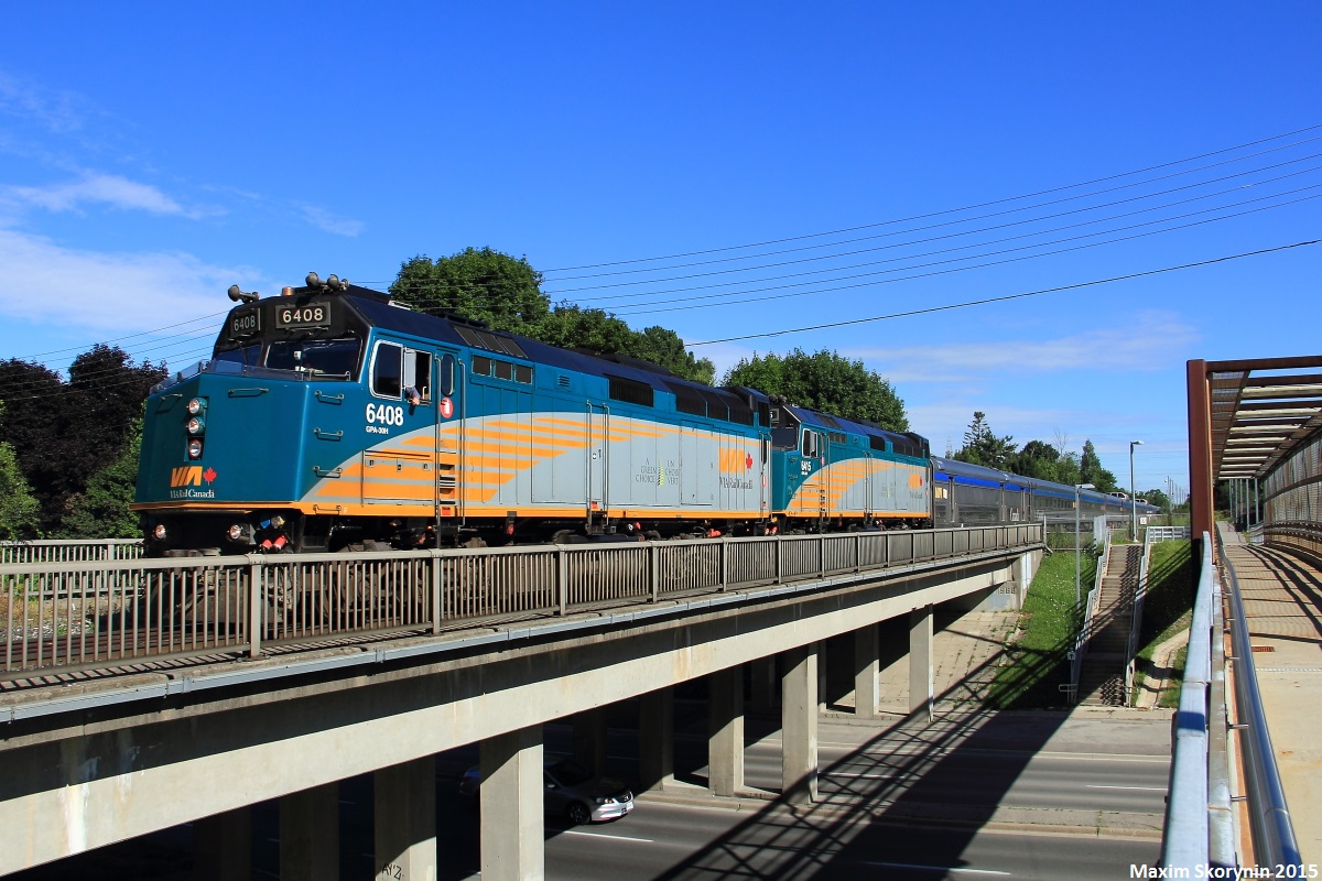 VIA #02 slowly creeps over Finch Avenue East near Bayview Woods, Ontario and just south of Old Cummer GO Station. 02 is closely following the last southbound GO Train into downtown Toronto from Richmond Hill, GO 838, so they had a restricting signal.