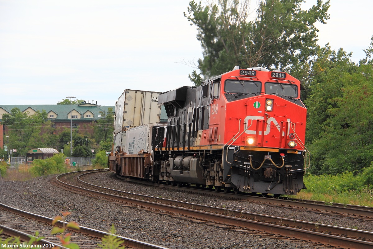Northbound intermodal Q10721, a daily Montreal to Winnipeg train rounds the curve approaching the Centre St E road crossing in Richmond Hill with a solo ES44AC to handle all the stacks. This train, would meet 'The Canadian' VIA #02 at Quaker before proceeding again on its way to Winnipeg.