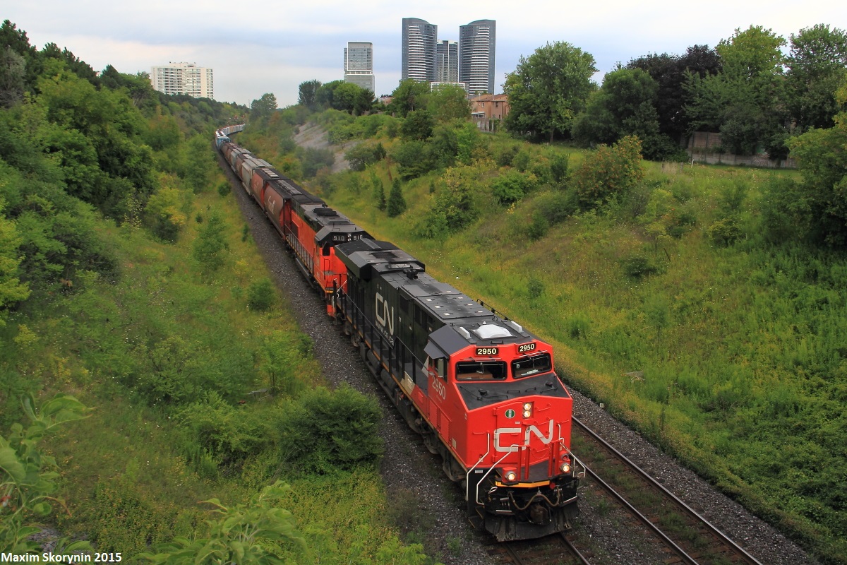 The daily Chambord to Toronto manifest is pulling into Toronto with a ES44AC leading Bessemer & Lake Erie EMD SD40-3T 910, and another 44AC helping out mid-train. The BLE 910, was purchased by Canadian National and was online and working on this train, as it ducked under the Hilda Avenue road bridge on its way to Toronto's MacMillan Yard.