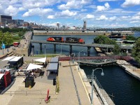 A pair of GP9's (CN 7083 & CN 7020) head light over the eastern end of the Lachine canal in old Montreal. 