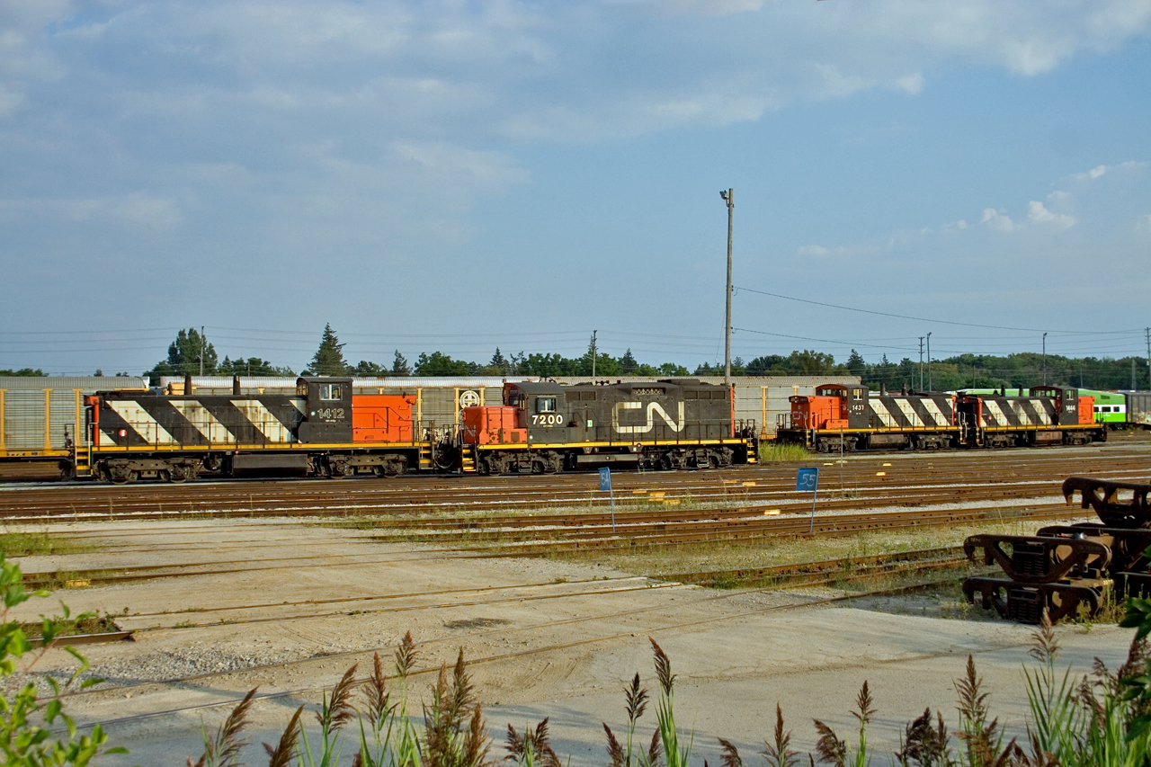 All is quiet at Oakville Yard this pleasant Sunday evening, as GMD1 1412 and GP9 7200 await their call to duty.  In the background, units 1437 and 1444 rest after working around Oakville on train 556.  Soon the silence will be broken, as the crew fires up GP38-2Ws 4768 and 4770 (out of sight) for the evening assignment 557, servicing industries on the mainline between Oakville and Burlington.  The railway never sleeps!